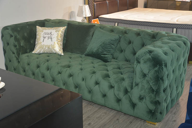 Classic upholstered sofa with many button tufts